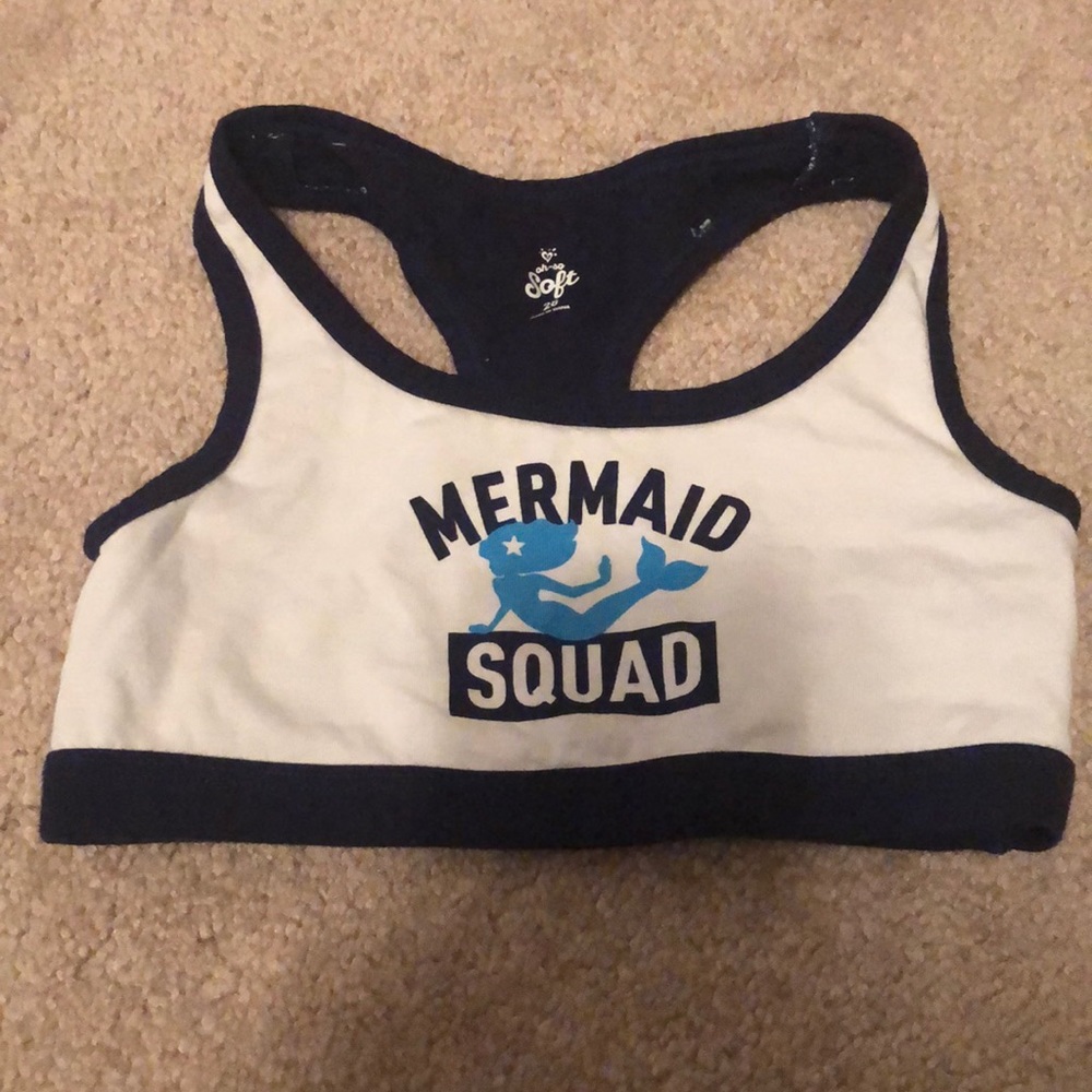 a justice sports bra with mermaid squad on it